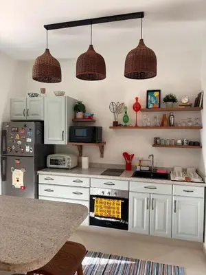 a kitchen with white cabinets and a stove top oven at Cozy 1BR in the Heart of Gouna in Hurghada