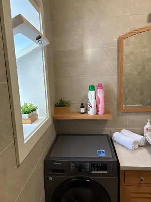 a washing machine in a bathroom with a window at Cozy 1BR in the Heart of Gouna in Hurghada