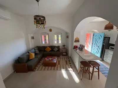 a living room with a couch and a table at Cozy 1BR in the Heart of Gouna in Hurghada