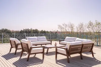 a patio with three chairs and a table and a couch at Luxury 5BD Villa with Pool in Hurghada