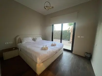 a bedroom with a bed with two shoes on it at Luxury 4BR Cyan Villa • Private Pool in Hurghada