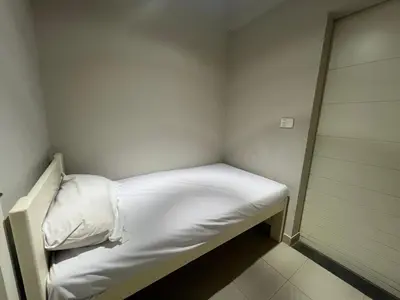 a small room with a bed with white sheets at Luxury 4BR Cyan Villa • Private Pool in Hurghada