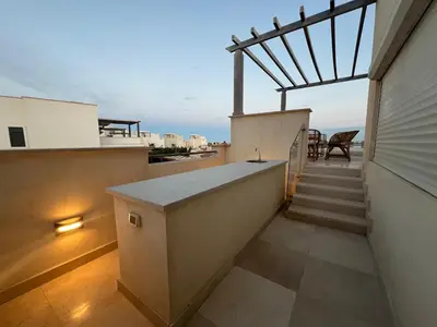 a balcony with stairs and a view of the ocean at Luxury 4BR Cyan Villa • Private Pool in Hurghada