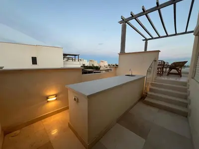 a balcony with stairs and a view of the ocean at Luxury 4BR Cyan Villa • Private Pool in Hurghada