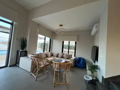 a living room with a couch and chairs and a table at Luxury 4BR Cyan Villa • Private Pool in Hurghada