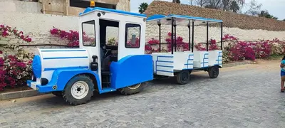 a blue and white train car parked next to a building at Alhambra Avenue in Hurghada