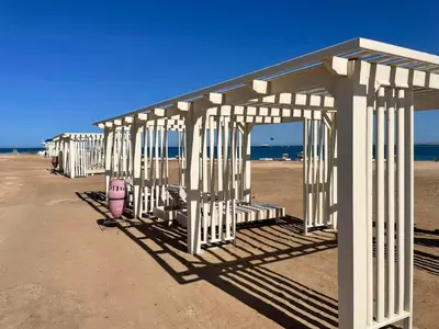 a row of white structures on the beach at Alhambra Avenue in Hurghada