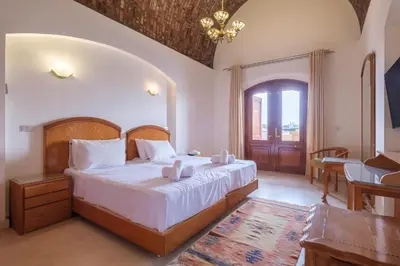 a bedroom with a bed with two candles on it at Serene 4BR Villa • Authentic West Golf in Hurghada