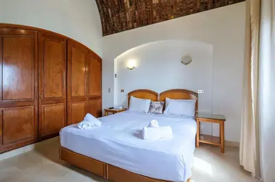 a bedroom with a bed with two towels on it at Serene 4BR Villa • Authentic West Golf in Hurghada