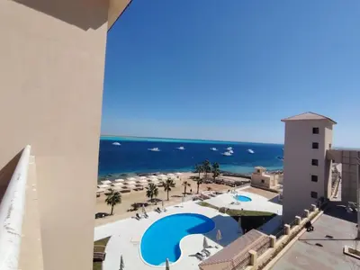 a view of the beach from the balcony of a resort at Studio for rent in the view 409 in Hurghada