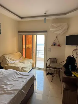 a bedroom with a bed and a desk and a table at Studio in Casablanca 631 in Hurghada