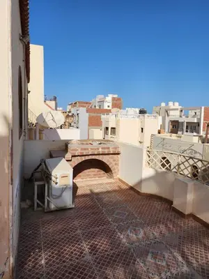 a view of a building with a bridge and buildings at 2BD Apt, Douplex, 2 floors, Villa Yanny, El Helal, Hurghada in Hurghada