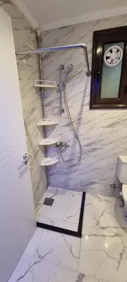 a bathroom with a shower and a toilet at Turtles Beach Resort Al Ahyaa in Hurghada