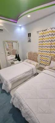a room with two beds and a couch in it at Turtles Beach Resort Al Ahyaa in Hurghada