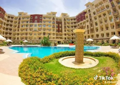 a large building with a large pool in front of it at Florenze Khamsin Hurghada in Hurghada