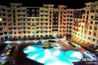 a large pool in front of a large building at Florenze Khamsin Hurghada in Hurghada