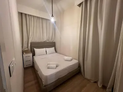 a bedroom with a bed with two towels on it at Ancient Sands 4BR • Heated Pool Twin-Villa in Hurghada