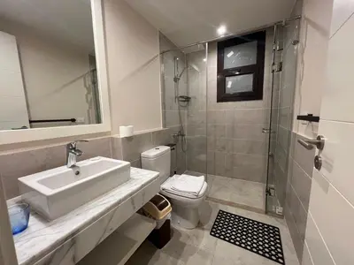 a bathroom with a sink and a shower and a toilet at Ancient Sands 4BR • Heated Pool Twin-Villa in Hurghada