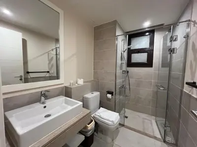 a bathroom with a sink and a toilet and a shower at Ancient Sands 4BR • Heated Pool Twin-Villa in Hurghada