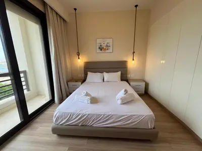 a bedroom with a bed with two pillows on it at Ancient Sands 4BR • Heated Pool Twin-Villa in Hurghada