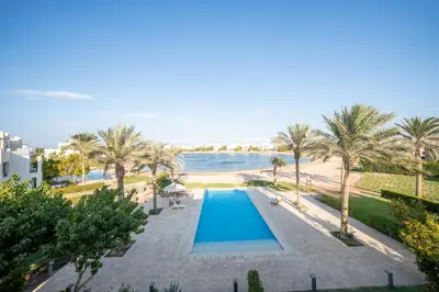 an overhead view of a swimming pool next to a beach at Joubal 2BR • Top Floor Lagoon View in Hurghada