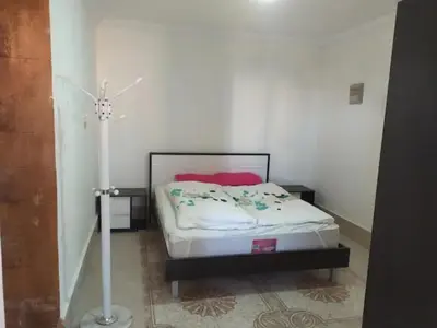 a bedroom with a bed in a room at One bedroom flat with large terrace in a villa with swimming pool in Hurghada