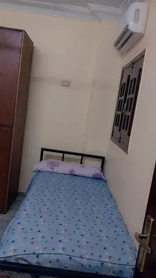 a bedroom with a bed in a room at Luxor downtown in Jazīrat al ‘Awwāmīyah