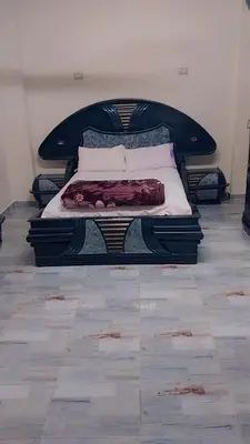 a bed sitting in a room with at Luxor downtown in Jazīrat al ‘Awwāmīyah