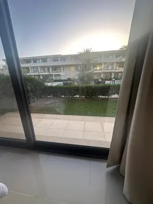 an open window with a view of a building at Hotel apartment G Cribs Hotel in Hurghada