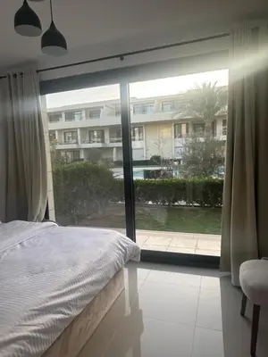 a bedroom with a bed and a large window at Hotel apartment G Cribs Hotel in Hurghada