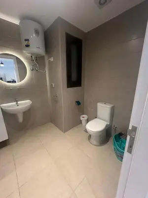 a bathroom with a toilet and a sink at Hotel apartment G Cribs Hotel in Hurghada