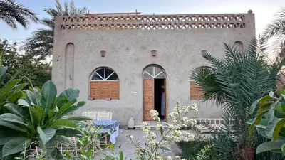 a building with a door and some plants at Beit El-Abd Valley of Queens View in Luxor