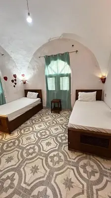 a bedroom with two beds and a carpet at Beit El-Abd Valley of Queens View in Luxor