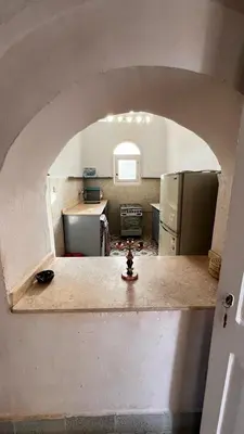 a kitchen with an archway in the middle of it at Beit El-Abd Valley of Queens View in Luxor