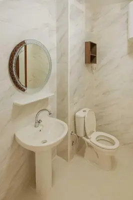 a bathroom with a toilet and a sink and a mirror at Golden tiba resort in Hurghada