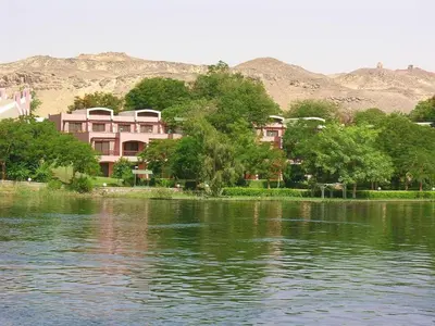 a group of houses on the shore of a body of water at Five stars Hotel included Aswan Sightseeing and Abusimble in Nag` el-Ramla
