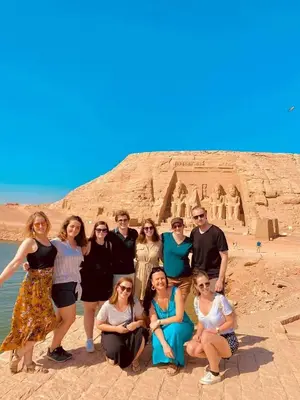 a group of people posing in front of thearaoharaoh at Five stars Hotel included Aswan Sightseeing and Abusimble in Nag` el-Ramla