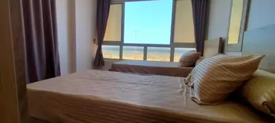 a bedroom with a bed with a large window at Sea View Qussier in Quseir