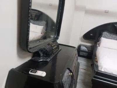 a mirror on a dresser with a cell phone on it at Horus apartment in Al Bayāḑīyah