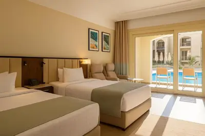 a hotel room with two beds and a balcony at SRNTY Sahl Hasheesh - Ex Serenity Sky Arc in Hurghada