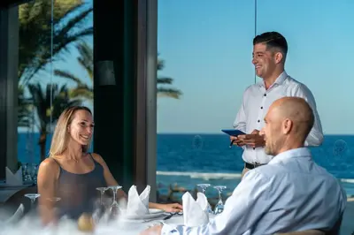 a group of people sitting around a table at a restaurant at SRNTY Sahl Hasheesh - Ex Serenity Sky Arc in Hurghada