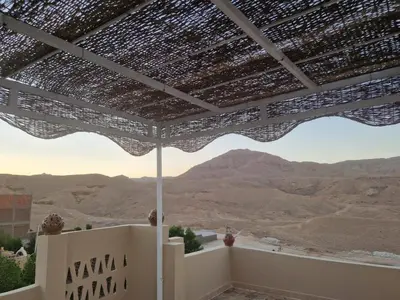 a view of the desert from the roof of a house at House Mountain in Luxor