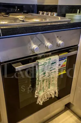 a towel is hanging on the door of an oven at Ladybird - Veranda Celestia in Hurghada