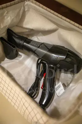 a black hair dryer sitting on a piece of paper at Ladybird - Veranda Celestia in Hurghada