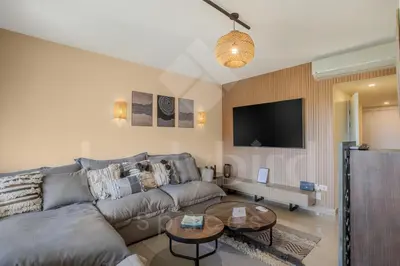a living room with a couch and a table at Ladybird - Veranda Celestia in Hurghada