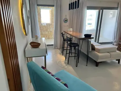 a living room with a blue couch and a table at Hotel apartment swan lake in Hurghada