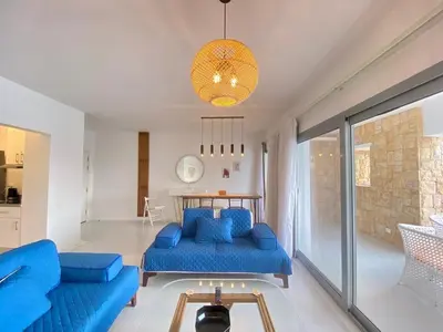 a living room with blue couches and a table at Hotel apartment swan lake in Hurghada