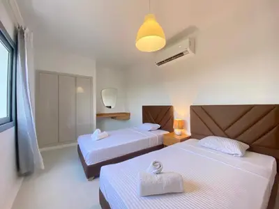 a hotel room with two beds and a light at Hotel apartment swan lake in Hurghada