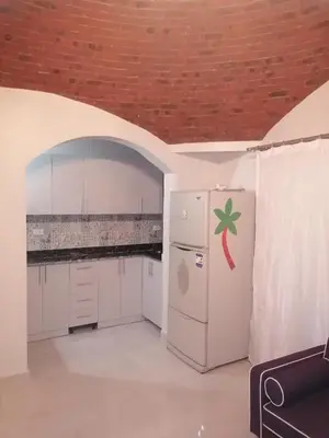 a kitchen with a white refrigerator and a brick ceiling at الكوثر القديم الغردقة in Hurghada
