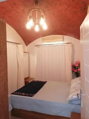 a bedroom with a bed and a chandelier at الكوثر القديم الغردقة in Hurghada